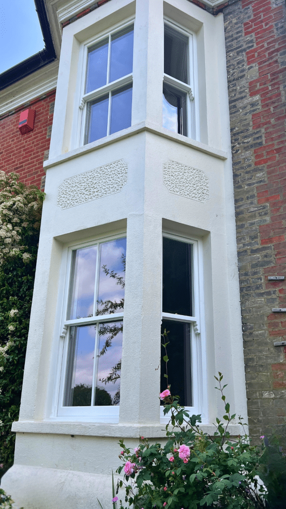 White timber sash windows in a period bay
