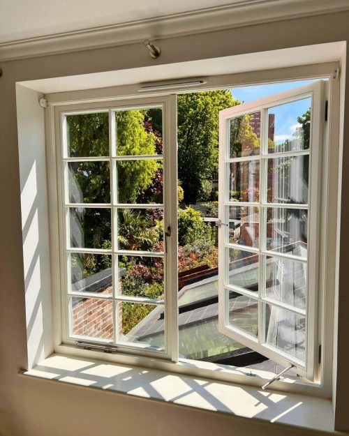 Open timber casement window with handle, stay and window ironmongery