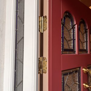 Adjustable brass hinges fitted to a timber entrance door