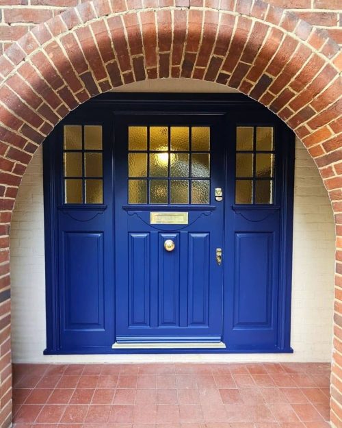 Timber front doors in blue paint in Edwardian design with brass door furniture