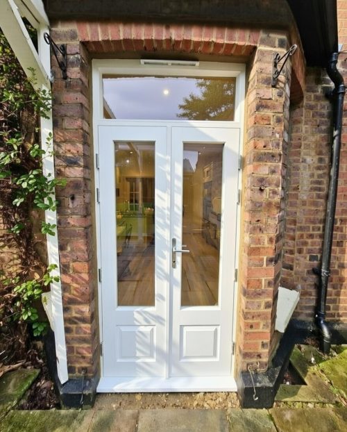 Timber French doors with fanlight and raised and fielded panels